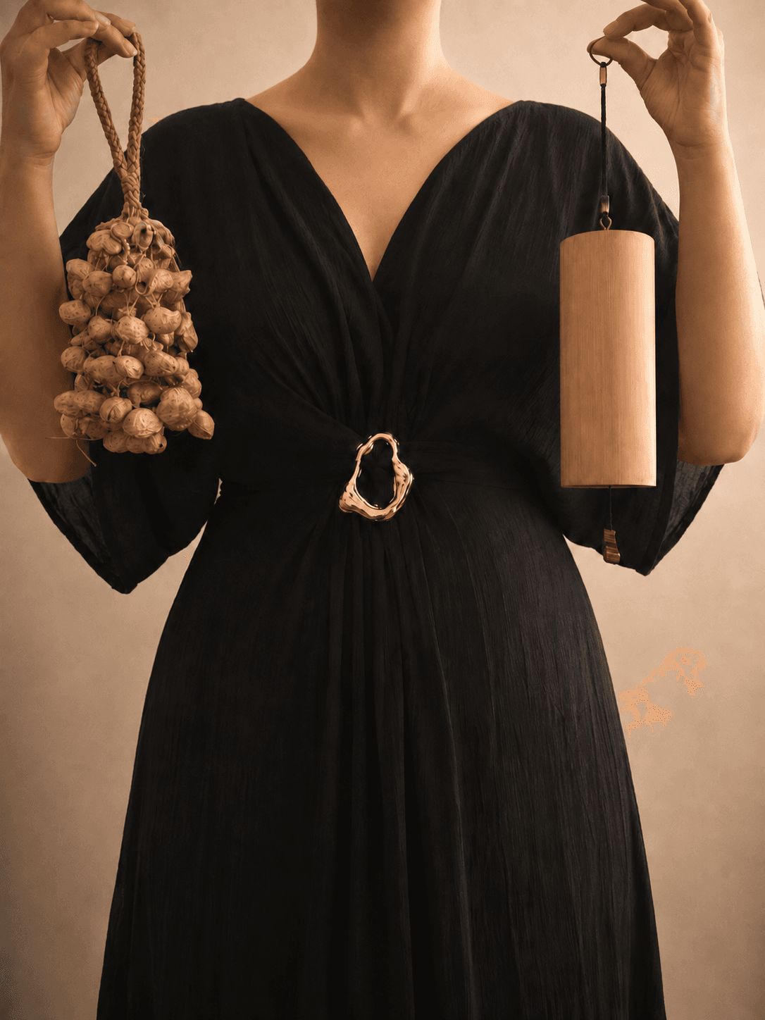 A wooden chime and a seed shaker held side by side