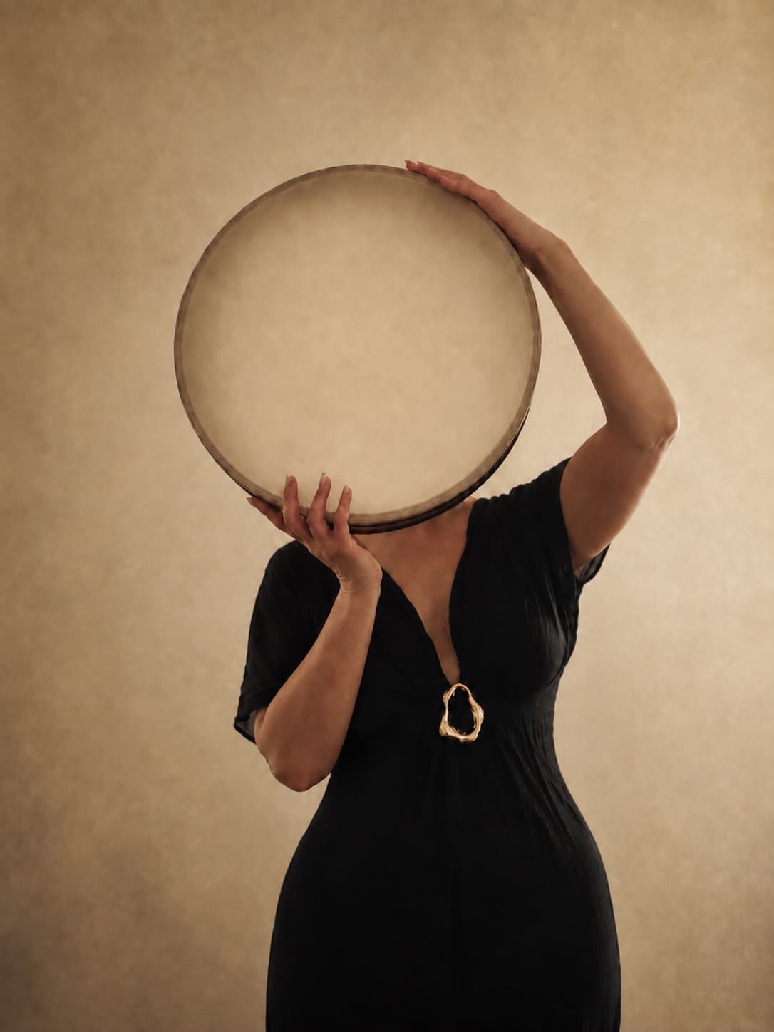 Alexandra holding a round ocean drum